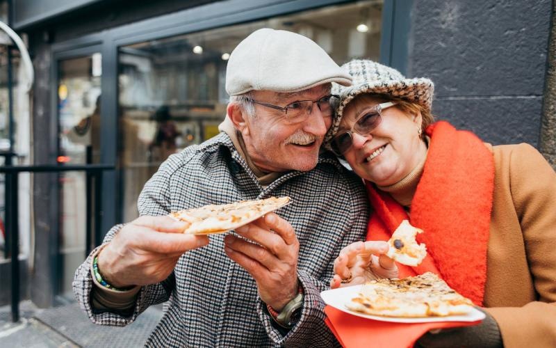 a couple eating pizza