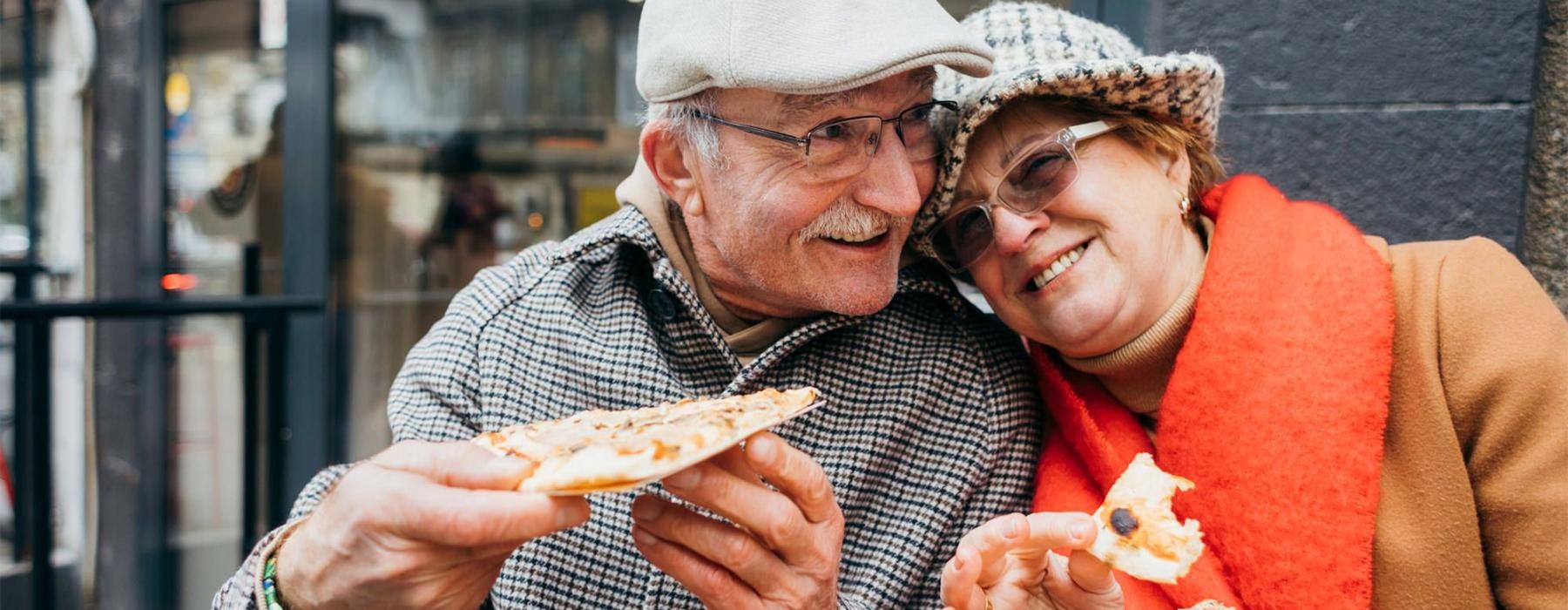 a couple eating pizza